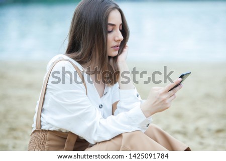 Similar – Image, Stock Photo Blonde woman looking at her smartphone outdoors