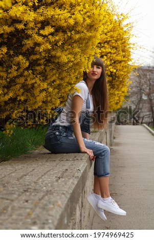 Beautiful young woman smiling and walking happy on the park outdoors