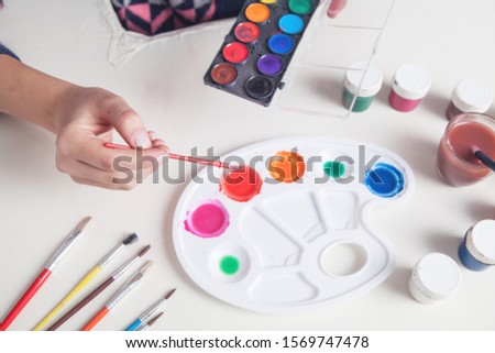 Girl painter holding brush. Work, Lifestyle