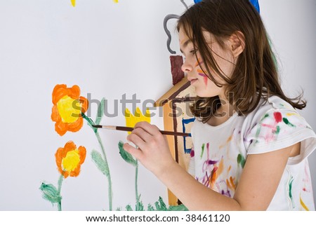 Girl painting on wall