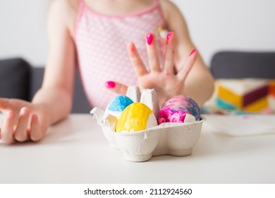 Girl Paints Easter Eggs At Home Against Background Of Bright Decor. Kids Craft. Create Art For Children