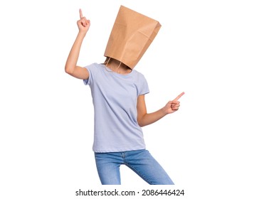 Girl with paper bag on her head dancing. Teenager cover face, isolated on white background. Happy child point fingers up.