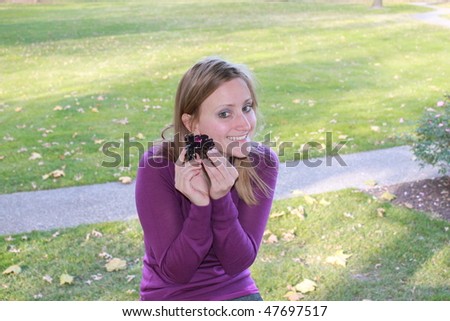Girl in a Park acting silly with flower bracelet