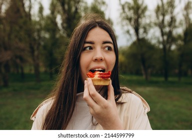 girl in the park eats faggots and smiles