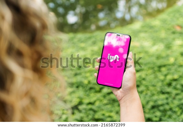 Girl in\
the park holding a smartphone with Lyft mobility company app on the\
screen. Rio de Janeiro, RJ, Brazil. May\
2022.