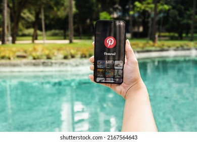 Girl In The Park Holding A Smartphone With Pinterest App On The Screen. Rio De Janeiro, RJ, Brazil. May 2022.