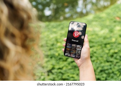 Girl In The Park Holding A Smartphone With Pinterest App On The Screen. Rio De Janeiro, RJ, Brazil. May 2022.