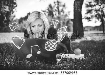 girl in park with laptop multimedia concept