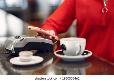 Girl Paying For Her Latte With A Smartphone By Contactless PAY PASS Technology