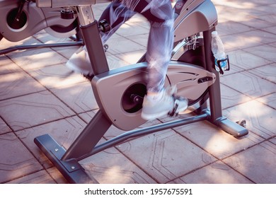 The Girl Pedals The Exercise Bike.