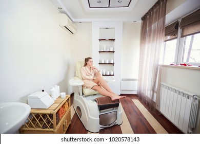 A Girl In A Pedicure Salon Sitting In A Chair.