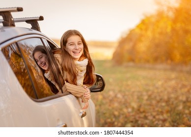 Girl Peeking Out Car Window