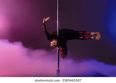 Girl performs impressive pole dance move with vibrant background lights - Powered by Shutterstock - Get 15% off with code: PIKWIZARD15