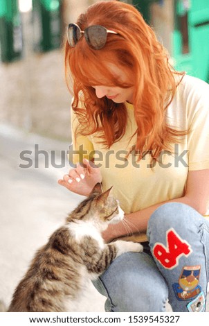 Girl is petting the cat