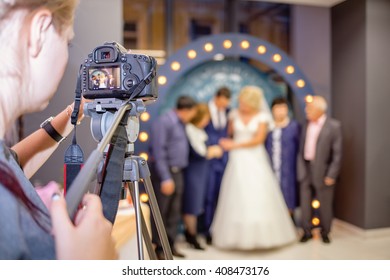 Girl Photographer With A Camera To Shoot The Wedding Video