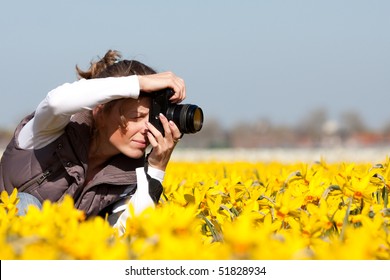 Girl photographer making pictures of flowers. Spring in the Netherlands - Powered by Shutterstock