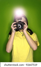 Girl photographer taking photo with digital camera and flash