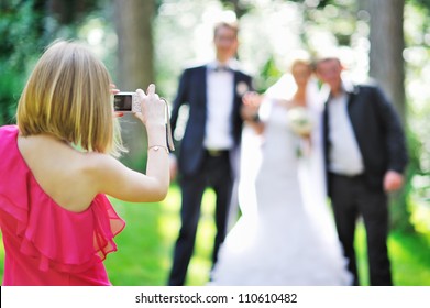 Girl photographing guests at the feast