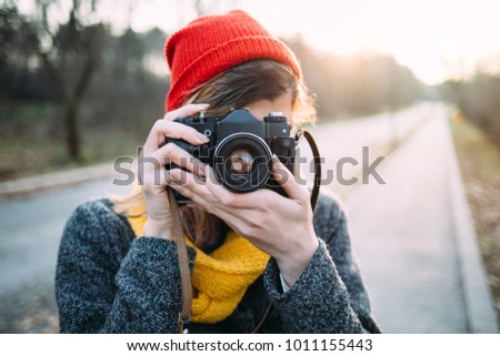 Similar – junge Frau beim Fotografieren mit Retro-Kamera auf Roadtrip