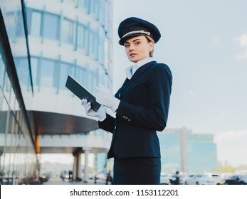 Girl Pilot Stands On The Street With A Tablet.