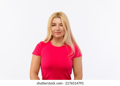 Girl In A Pink Dress On A White Background. With One Eye Open