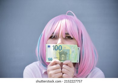 Girl In Pink Shirt And With Pink Color Hair Holding Cash Money Euro And Dollars. Bank Staff Portrait, Anime Hero Cosplay