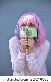 Girl In Pink Shirt And With Pink Color Hair Holding Cash Money Euro And Dollars. Bank Staff Portrait, Anime Hero Cosplay