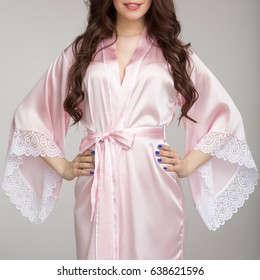 Girl In  Pink Silk Robe, On Gray Background