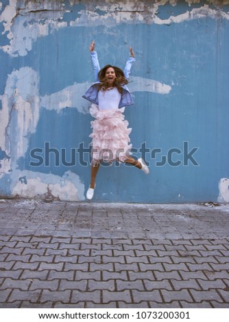 Similar – Image, Stock Photo Happy woman jumping in front of stone wall background