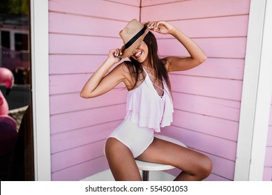 girl in pink swimsuit on pink background
