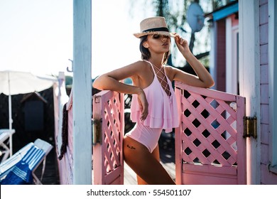 Girl In Pink Swimsuit On Pink Background