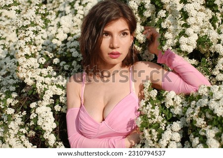 girl in a pink top on a floral backgroun