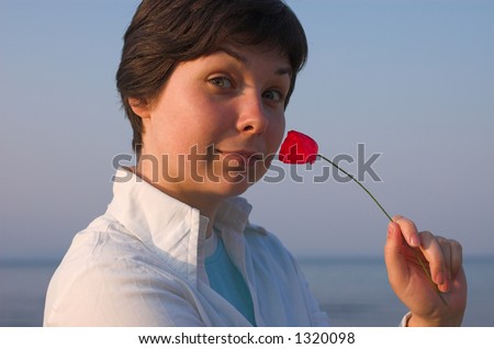 Girl with a pipe near her nose at the sea