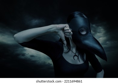 Girl In Plague Doctor Mask Showing Thumbs Down Over Dramatic Sky