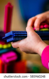 Girl Play With Colorful Bristle Block.