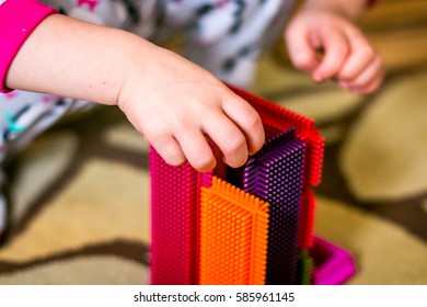 Girl Play With Colorful Bristle Block.