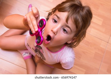 girl play with spinner pink - Powered by Shutterstock