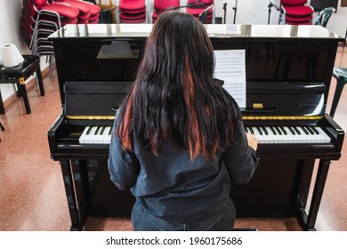 Girl Playing A Black Piano