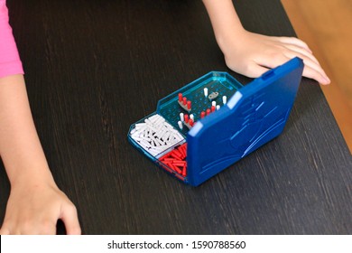 Girl Playing In The Board Game Battleship, Toy War Ships And Submarine. Selective Focus.