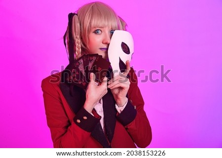 Girl with playing cards and mask in hands