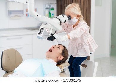 A Girl Playing With Dental Equipment During Her First Pediatric Dentistry Visit