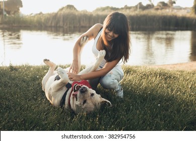 Girl playing with dog on grass