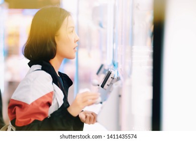 A Girl Playing Doll Catcher Game In Tokyo, Soft Focus In The Main Subject