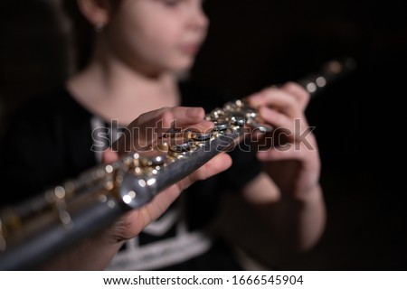 girl playing the flute, macro photo
