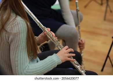 Girl playing flute in school children's orchestra background image of music lessons close up - Powered by Shutterstock