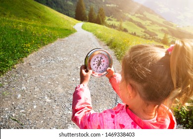 Girl Playing Geocaching Game In Mountains In Summer