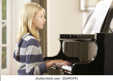 Girl Playing Grand Piano At Home