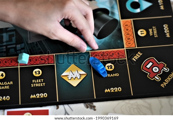 Girl playing Monopoly to sharpen her knowledge on\
how money and financial system works, Kuala Lumpur, Malaysia, 13\
June 2021