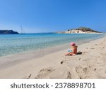 girl playing on the beach of elafonisos, simos beach, greece