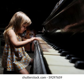  Girl Playing On An Old Black Piano